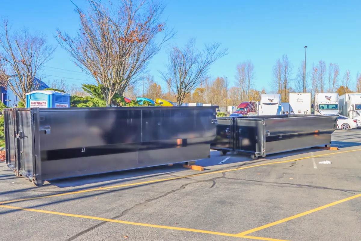 Professional dumpster rental service with roll-off container on residential driveway in Hastings
